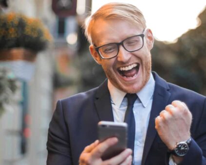 Man celebrating with successful message on phone