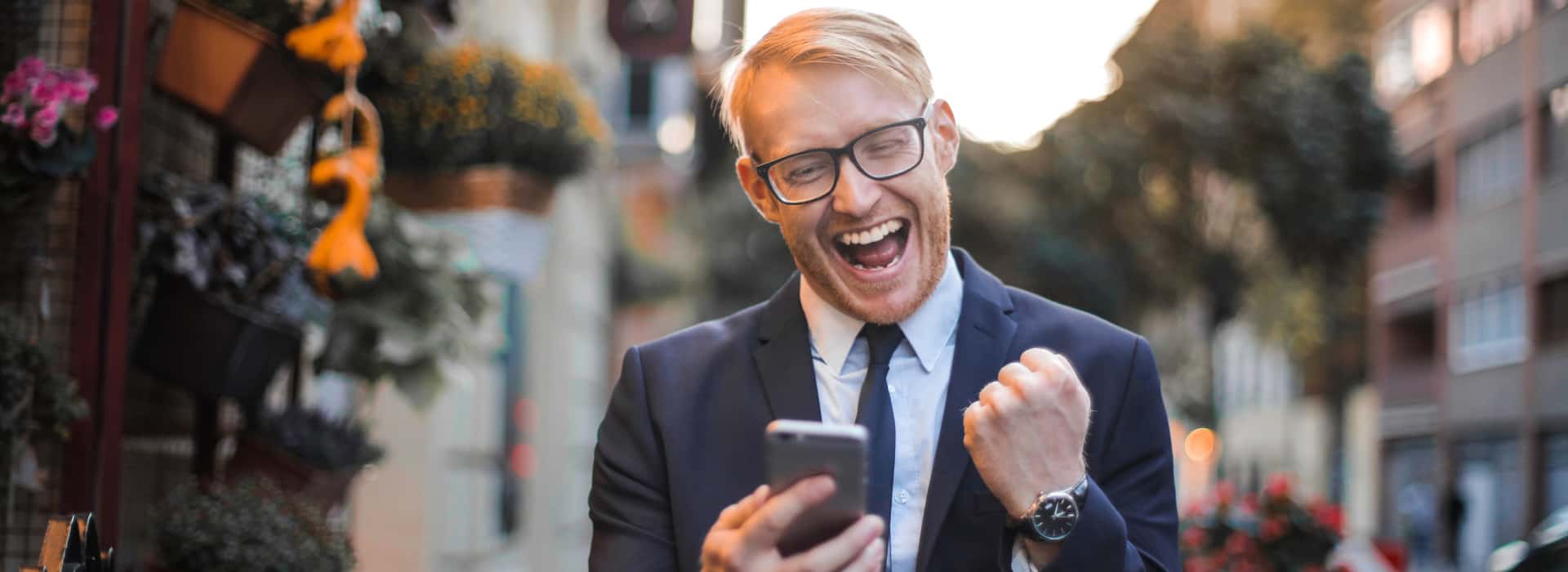Man celebrating with successful message on phone