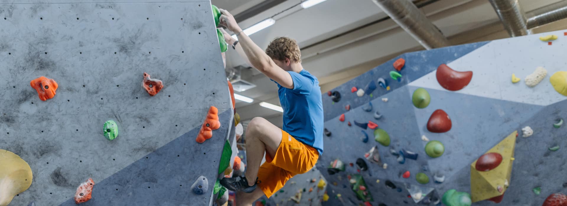 Person climbing on indoor rock wall