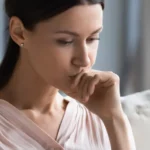 Lady pondering on couch
