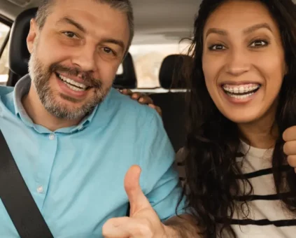 Happy couple driving in car