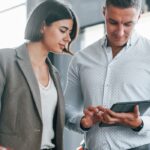 Couple reviewing loan application on tablet, exploring bad credit car loan options