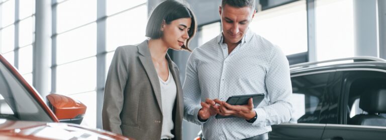 Couple reviewing loan application on tablet, exploring bad credit car loan options