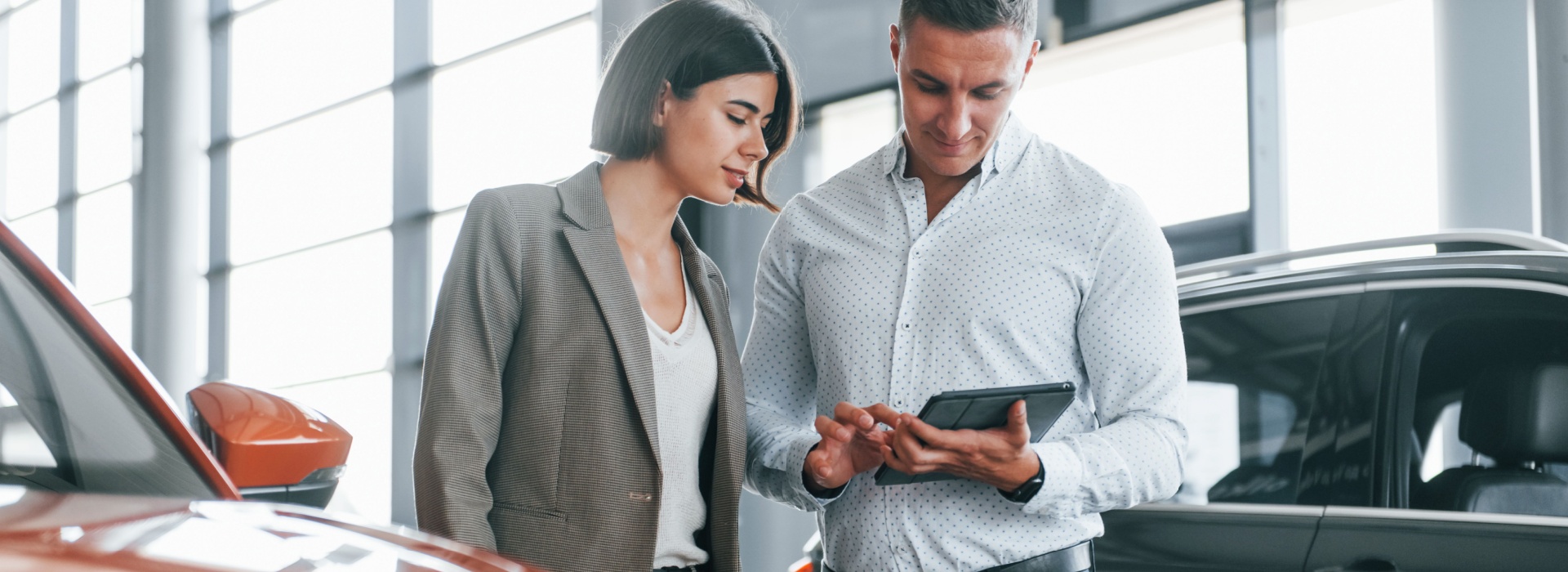 Couple reviewing loan application on tablet, exploring bad credit car loan options