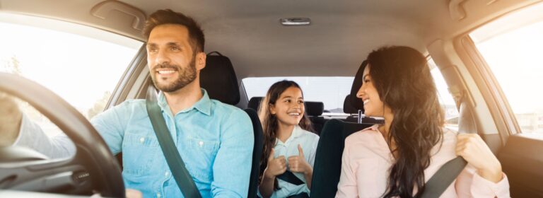 Happy family driving in car after securing a bad credit car loan